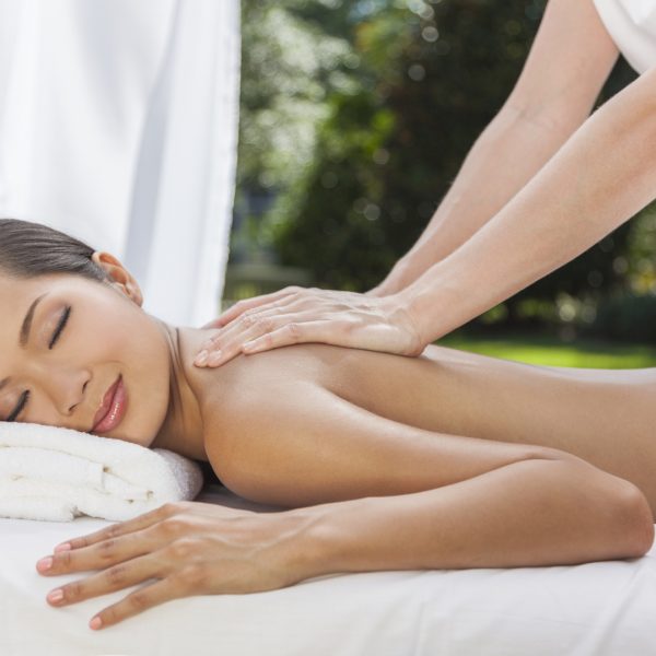 Woman Relaxing At Health Spa Having Massage